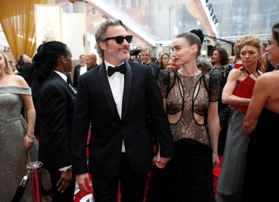 Joaquin Phoenix Wears a Suit With Sunglasses on Red Carpet Holding Hands With Fiance Rooney Mara in Cutout Dress