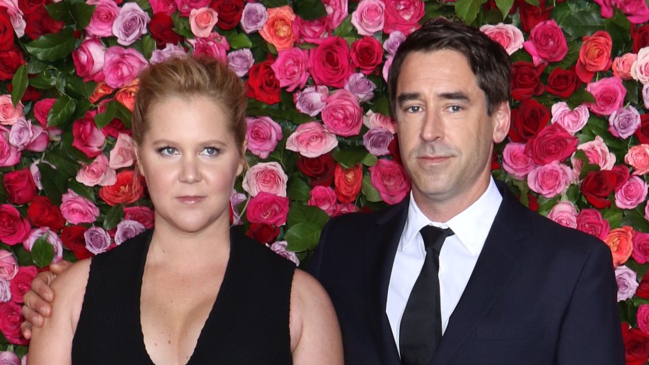 Amy Schumer in Black Gown and Husband Chris Fischer in Blue Suit Stand on Red Carpet Together