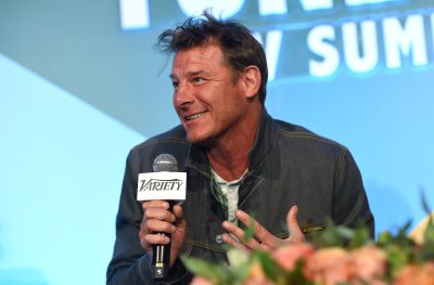 Ty Pennington Smiles Holding a Microphone