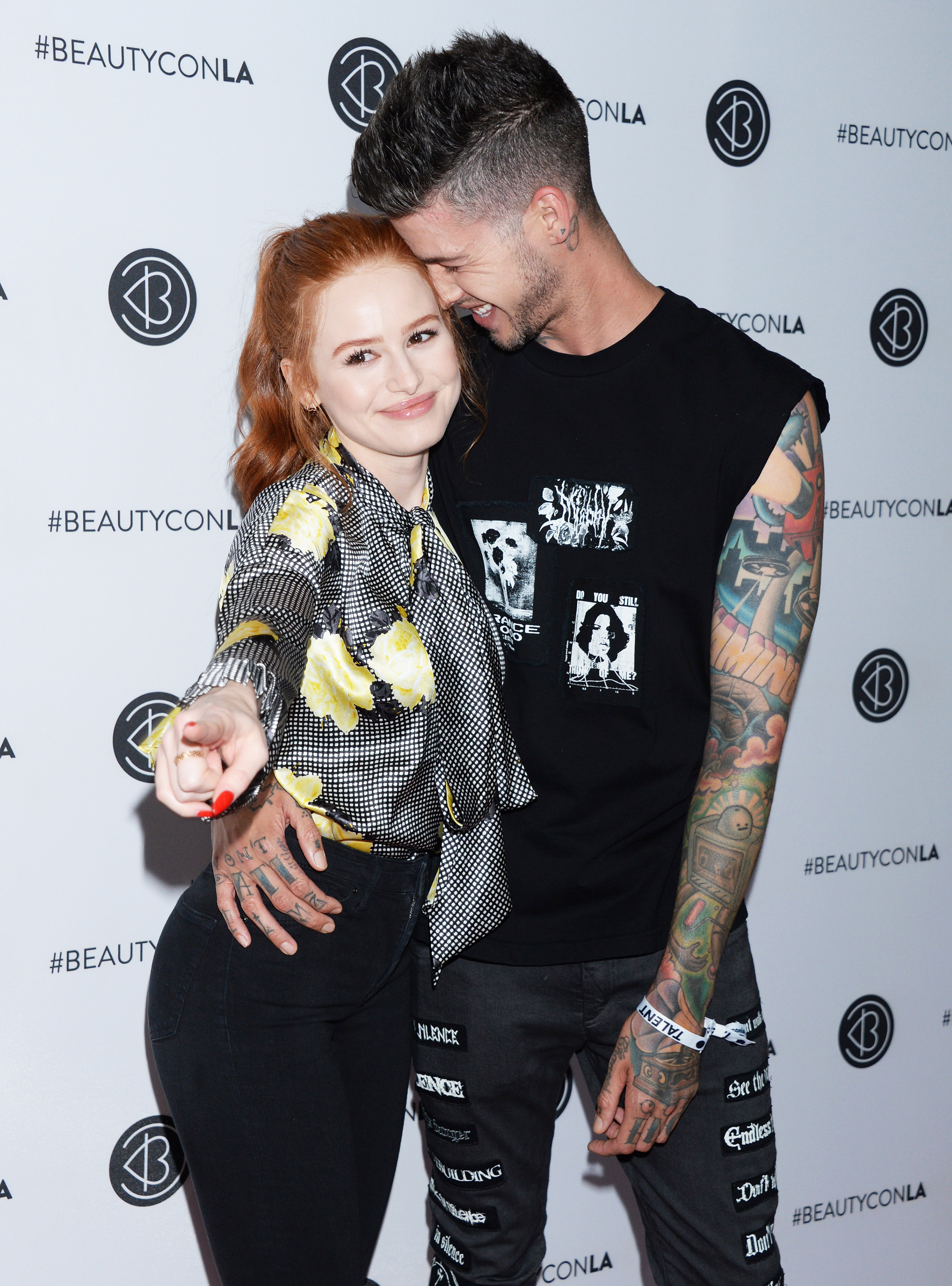 Madelaine Petsch and Boyfriend Travis Mills Kiss on the Red Carpet in Casual Clothing