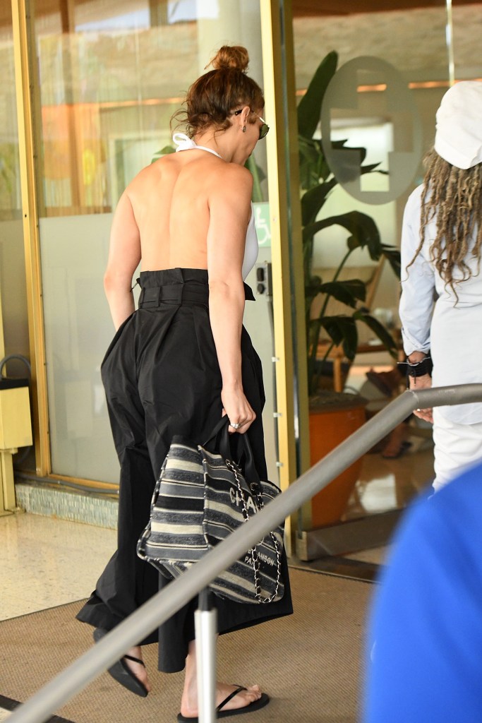 Jennifer Lopez shows off her back and a large Chanel bag as she heads out in Miami