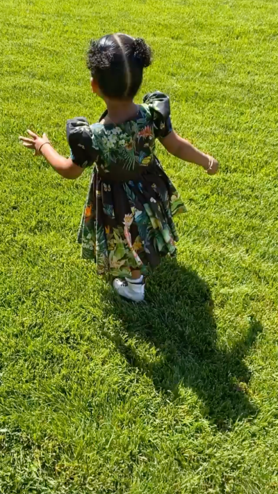 True Thompson Wearing a Floral Dress in Her Backyard