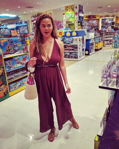 Chrissy Teigen Wears Maroon Jumpsuit and Headband in Target