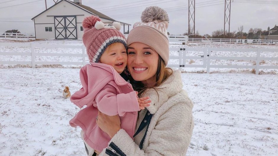 Bachelor Alum Jade Roper Wears Winter Coat and Hat With Puffball on Top While She Holds Daughter Emmy in Pink Jacket and Hat