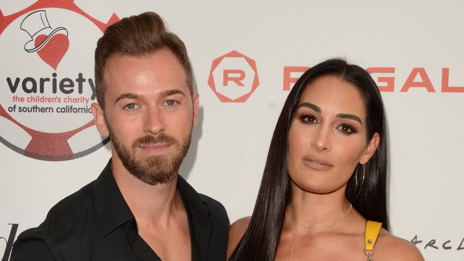 Nikki Bella Wears Yellow Pants and a Sheer Top With fiance Artem Chigvinstev in Blue Pants and Black Shirt