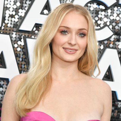 Sophie Turner Smiles in Pink Strapless Dress and Wavy Blonde Hair