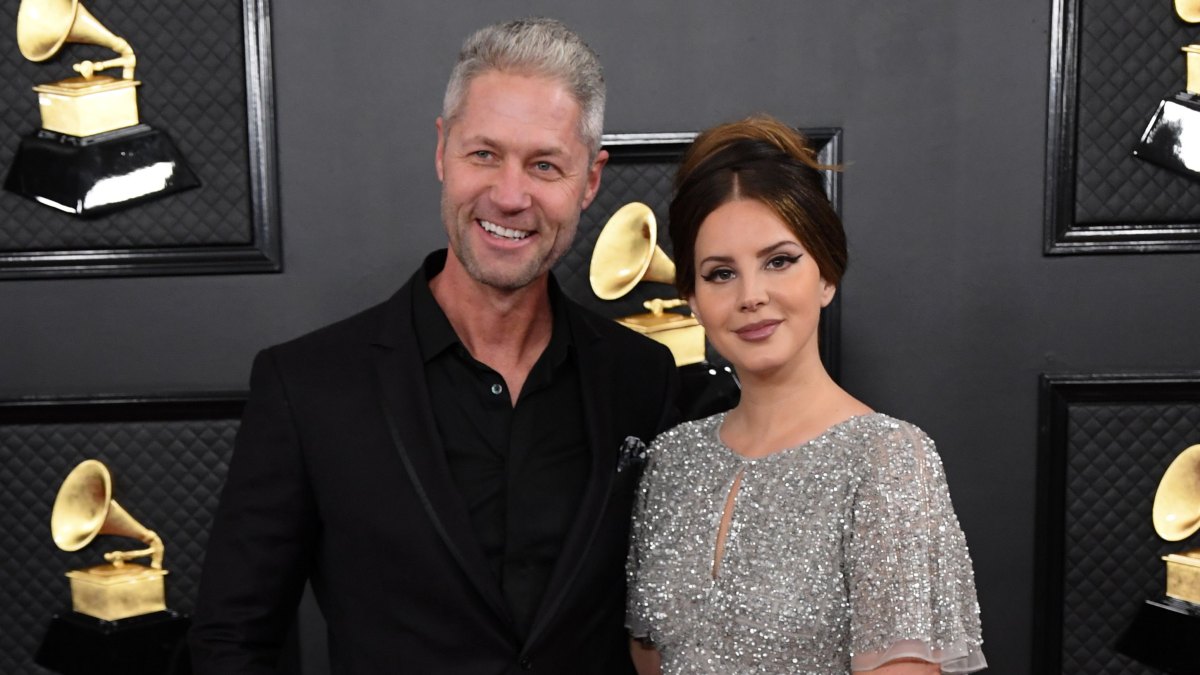 Lana Del Rey Wears Silver Short Sleeved Dress and Updo With Ex Boyfriend Sean Larkin in Black Suit at Grammys