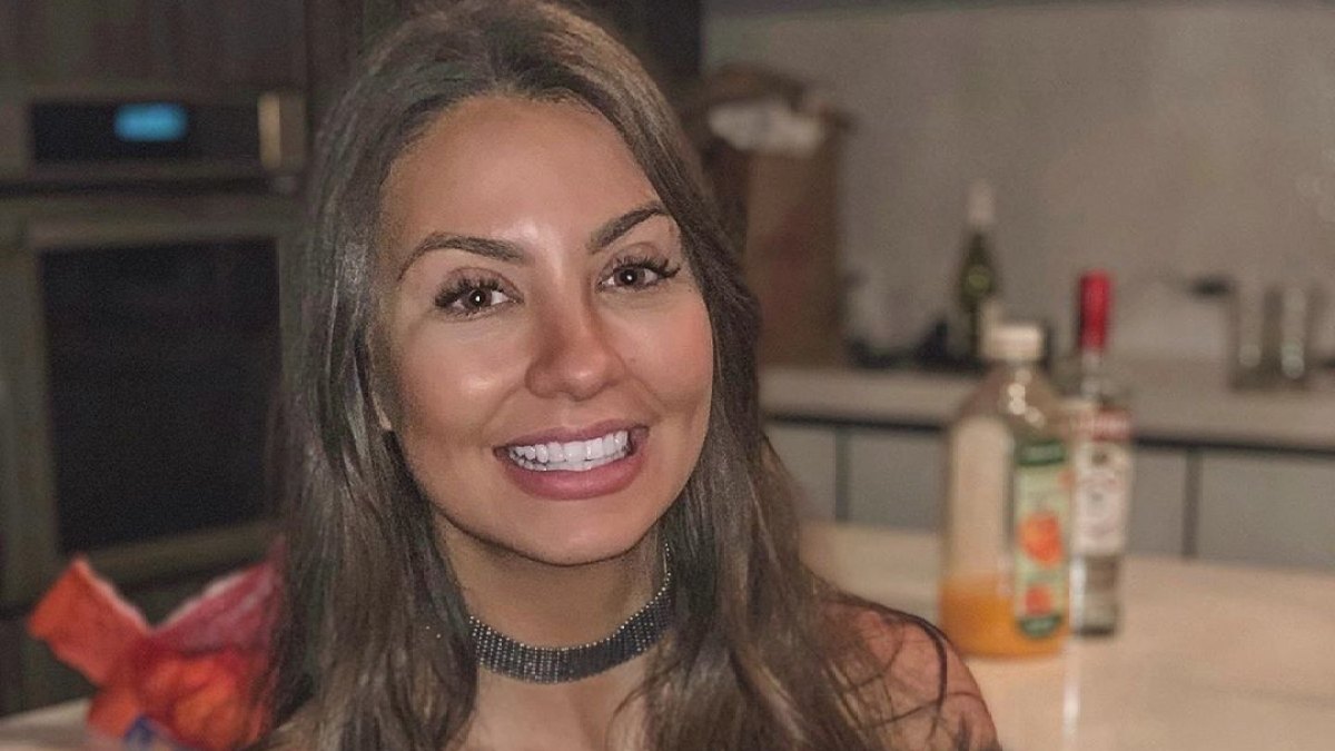 Bachelor Contestant Kelley Flanagan Smiles and Holds a Dog