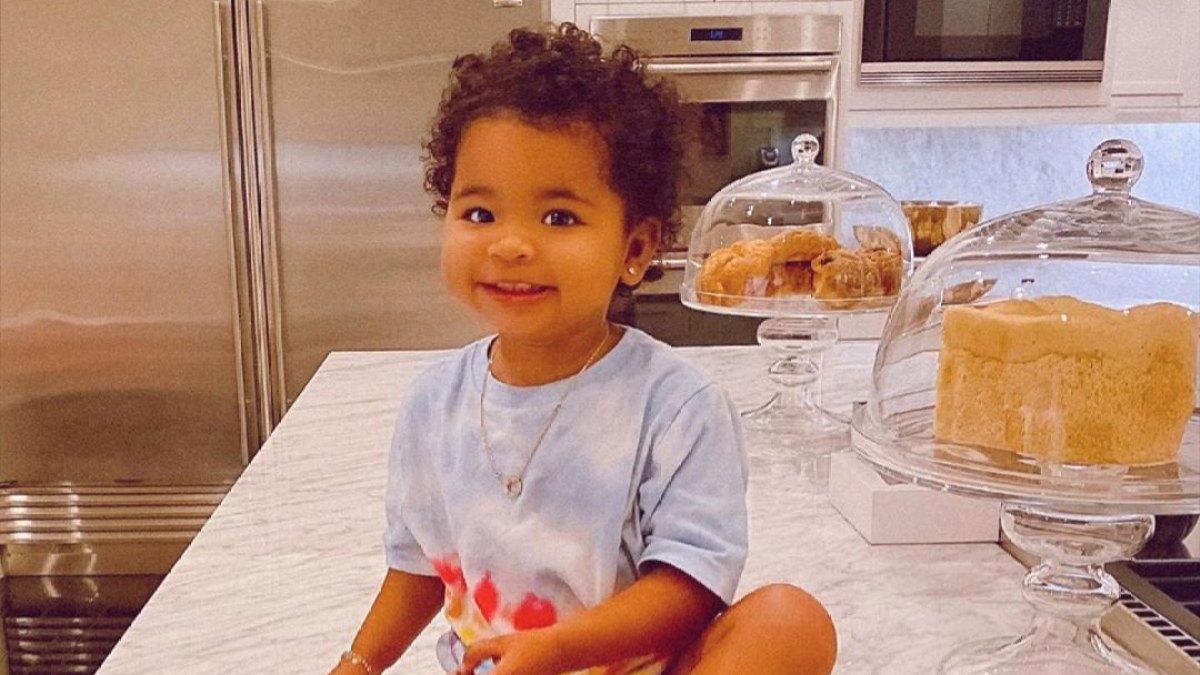 True Thompson Smiles in Front of a Loaf of Bread