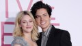 Cole Sprouse Smiles in Black Blazer and Striped Shirt With Arm Around Girlfriend Lili Reinhart in Frilly Dress