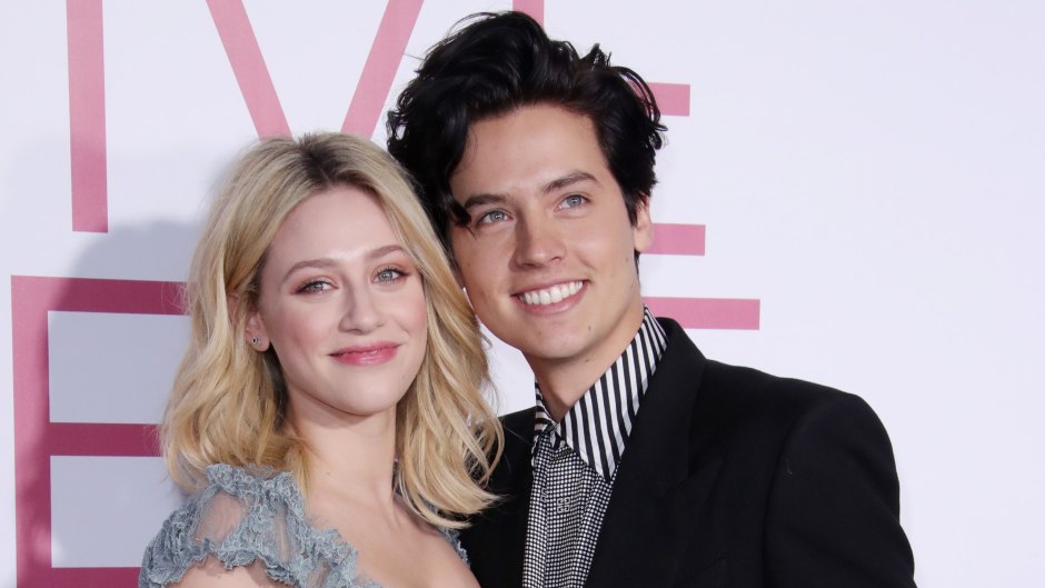 Cole Sprouse Smiles in Black Blazer and Striped Shirt With Arm Around Girlfriend Lili Reinhart in Frilly Dress