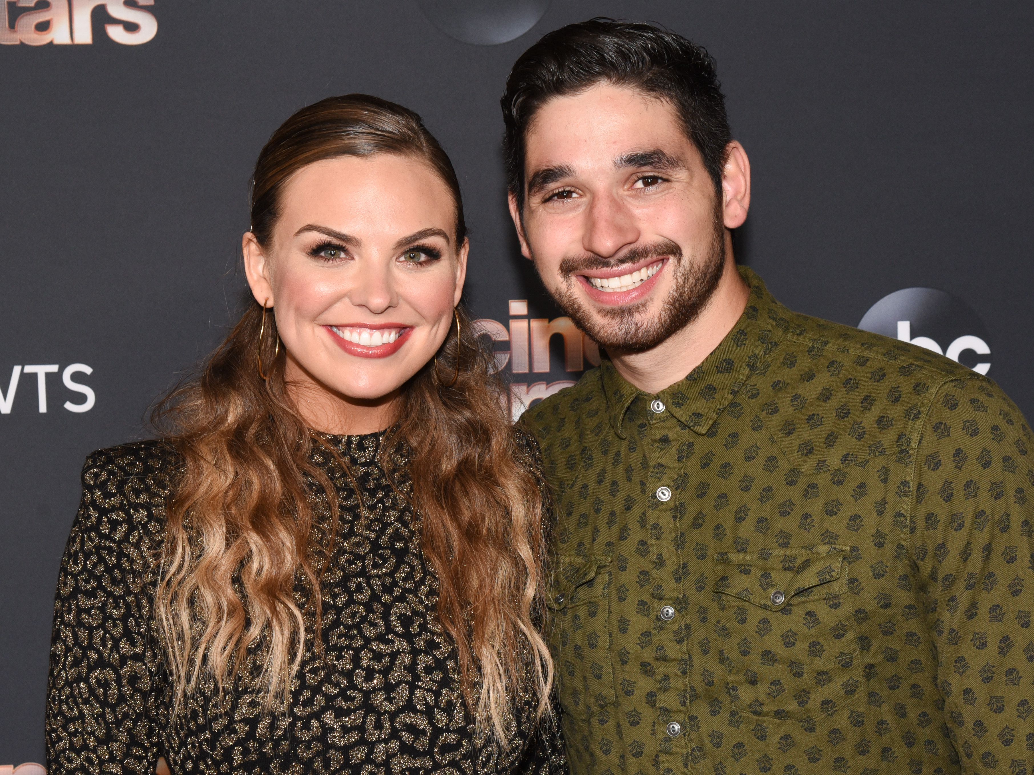 Bachelorette Hannah Brown Smiles With Hair Half Up in Cheetah Print Dress With DWTS Partner Alan Bersten