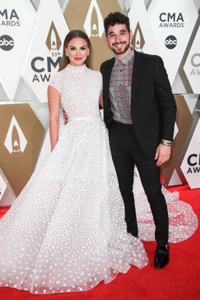 Hannah Brown Wears White Gown and Red Lipstick on CMA Red Carpet With DWTS Partner Alan Bersten in Brown Suit and Checkered Shirt