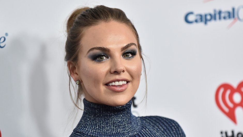 Hannah Brown Wears Turtleneck Blue Dress With Hair Pulled Up Into a Bun