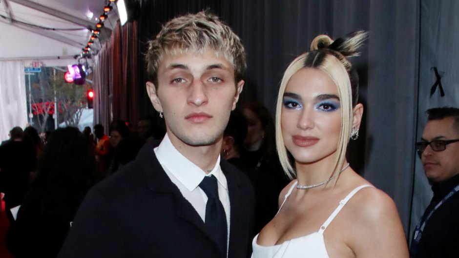 Dua Lipa Smiles in White Silk Gown With Hair in a Bun and Blue Eyeshadow With Boyfriend Anwar Hadid Wearing Black Suit at Grammys 2020