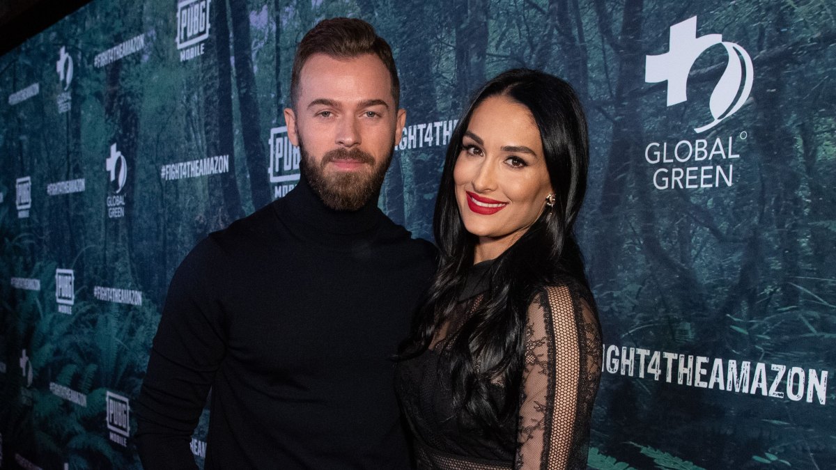 Nikki Bella Smiles in Black Dress and Red Lipstick With Fiance Artem Chigvintsev in Black Turtleneck