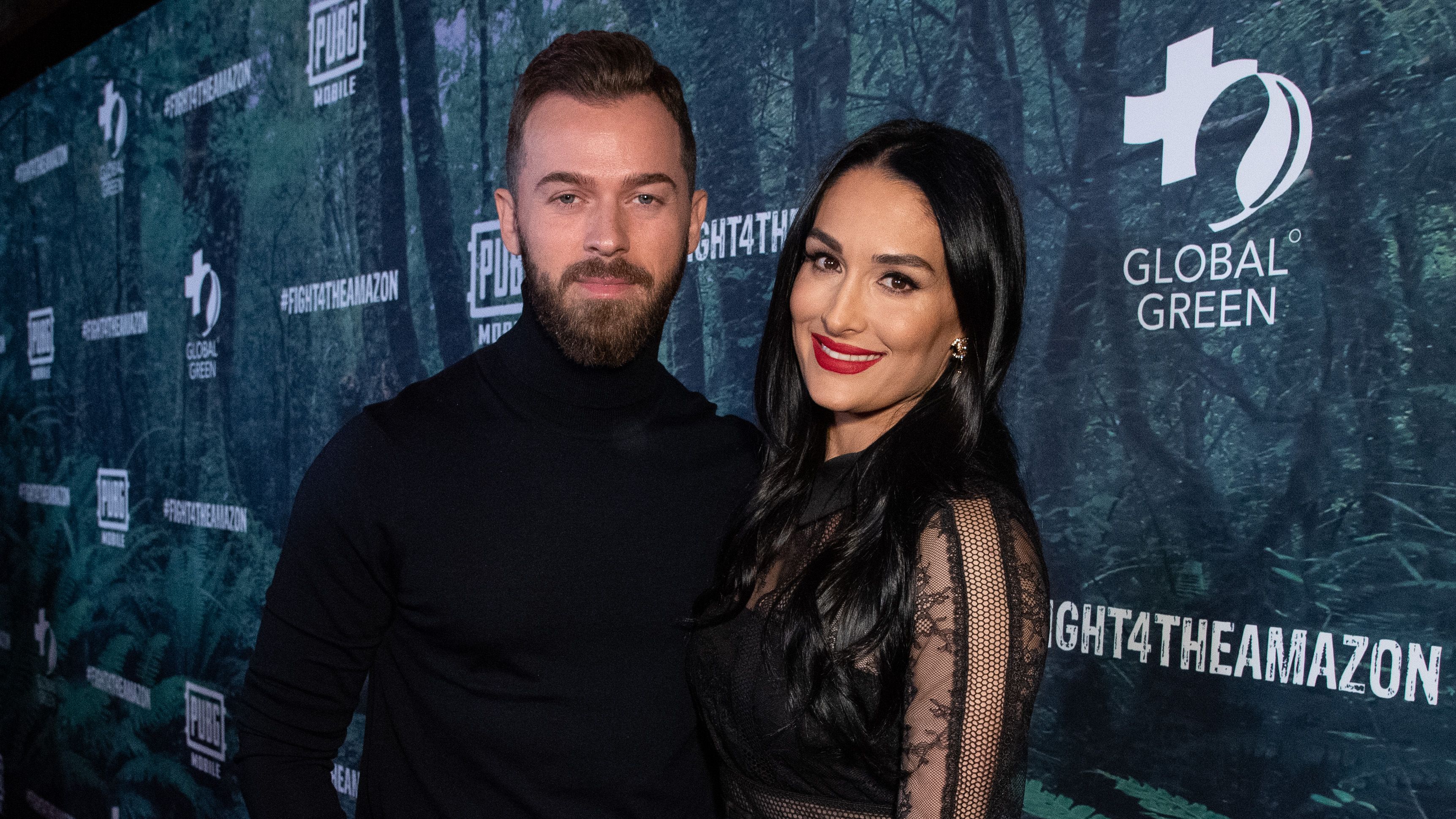 Nikki Bella Smiles in Black Dress and Red Lipstick With Fiance Artem Chigvintsev in Black Turtleneck