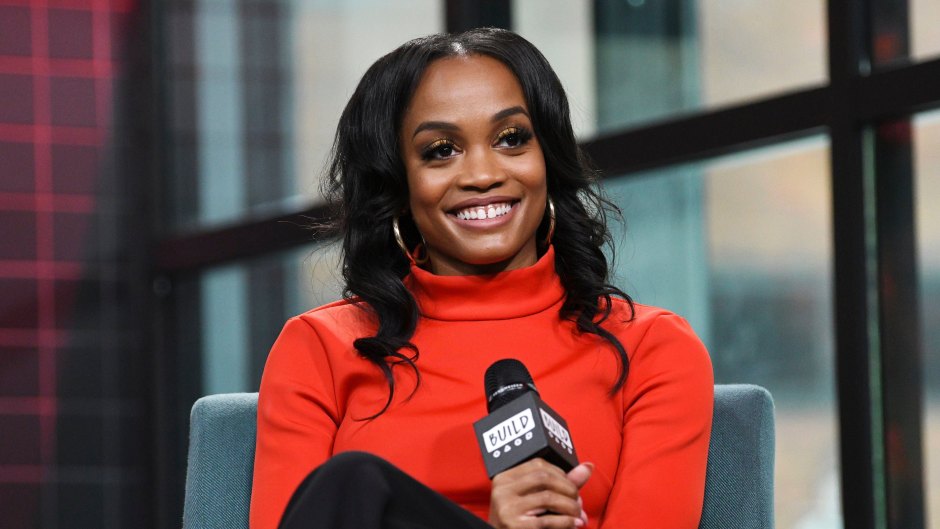Bachelorette Rachel Lindsay Wears Red Turtleneck and Hoop Earrings While Smiling Holding a Microphone