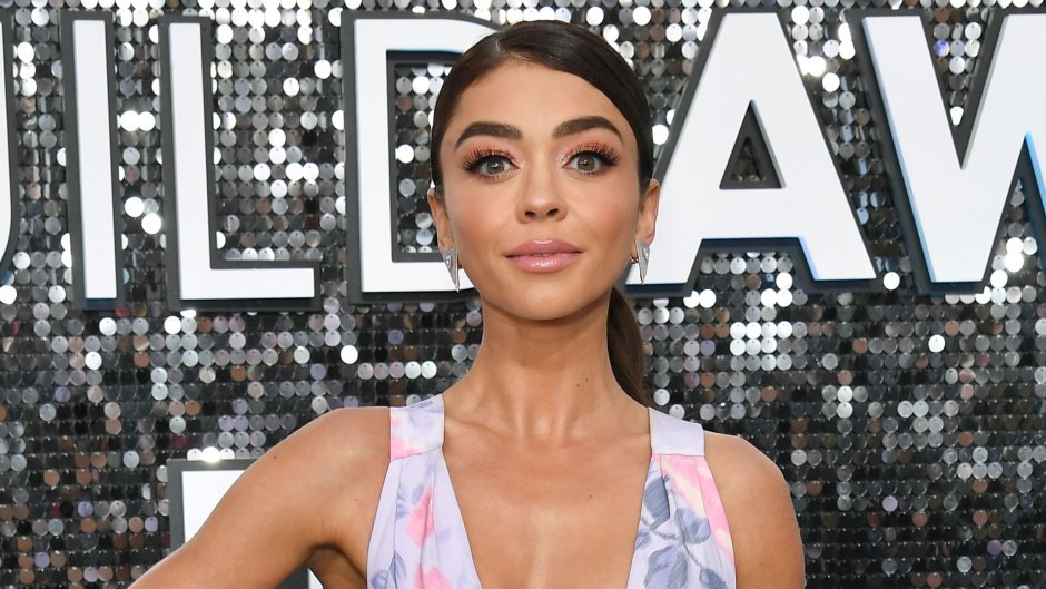 Sarah Hyland Stuns in Purple and Pink Flower Gown Plunging Neckline and Long Train