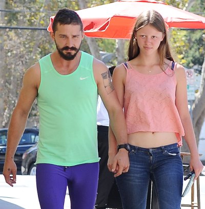 Shia LaBeouf and Mia Goth HOld Hands and Walk