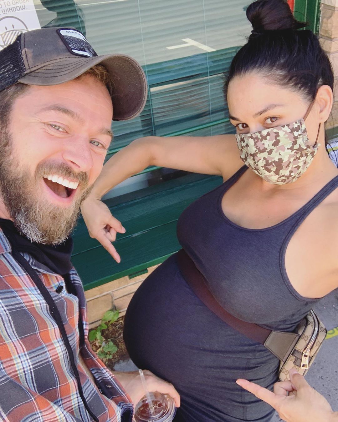 Nikki Bella Points to Baby Bump With Fiance Artem Chigvintsev
