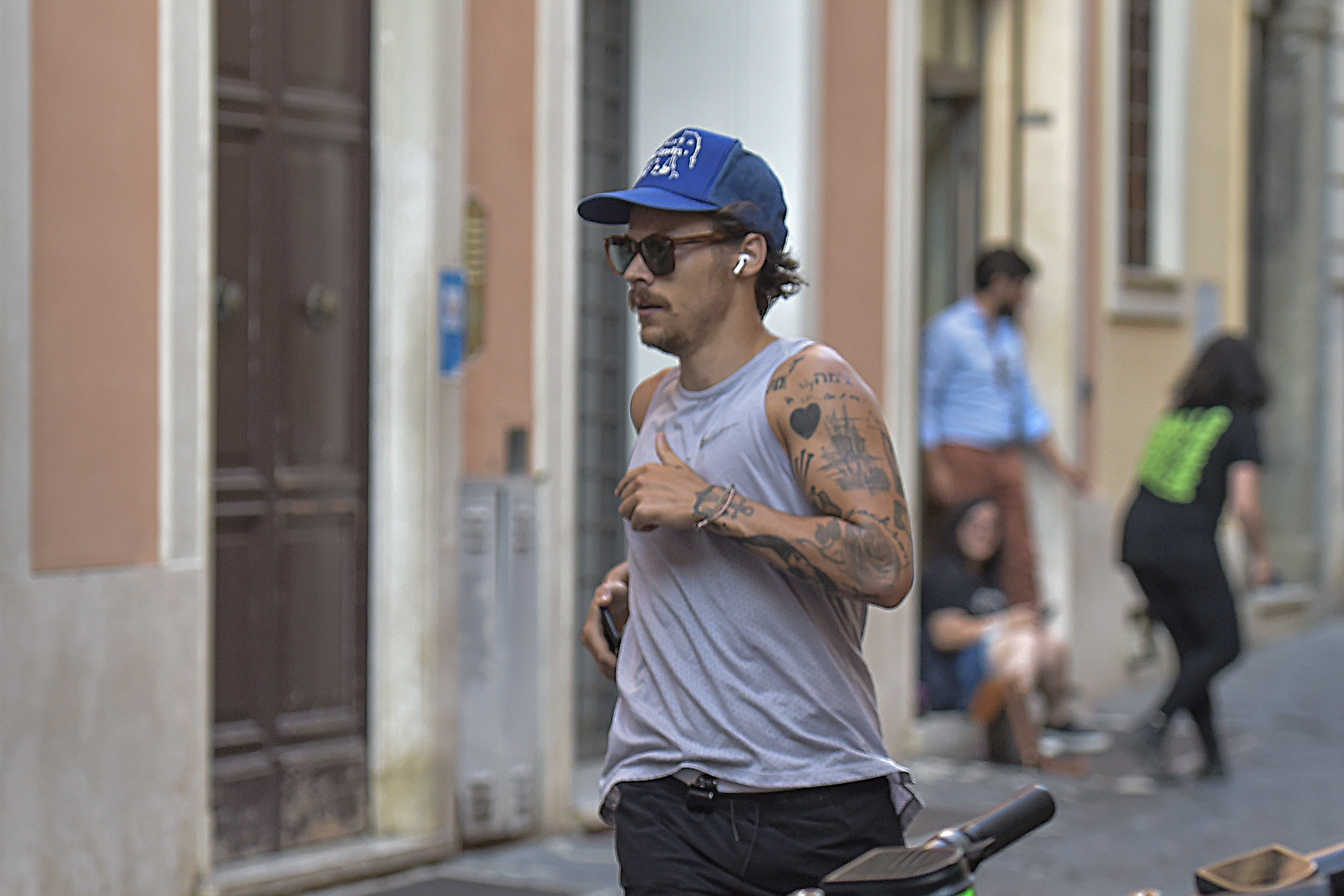 Harry Styles Running In Italy With New Mustache See Photos