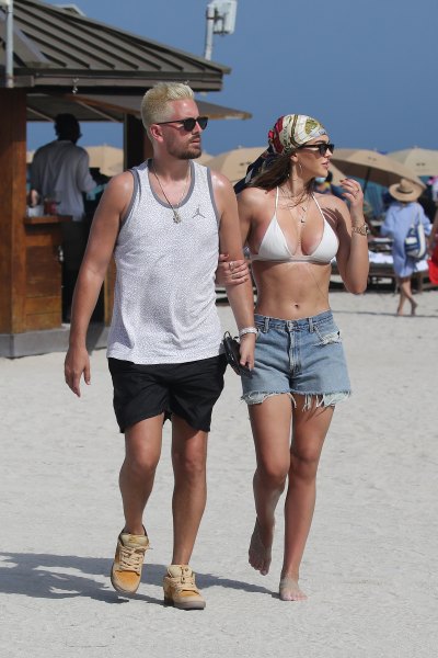 Amelia Hamlin shows off her curves in a white bikini as she hits the beach with boyfriend Scott Disick on Valentine's Day in Miami