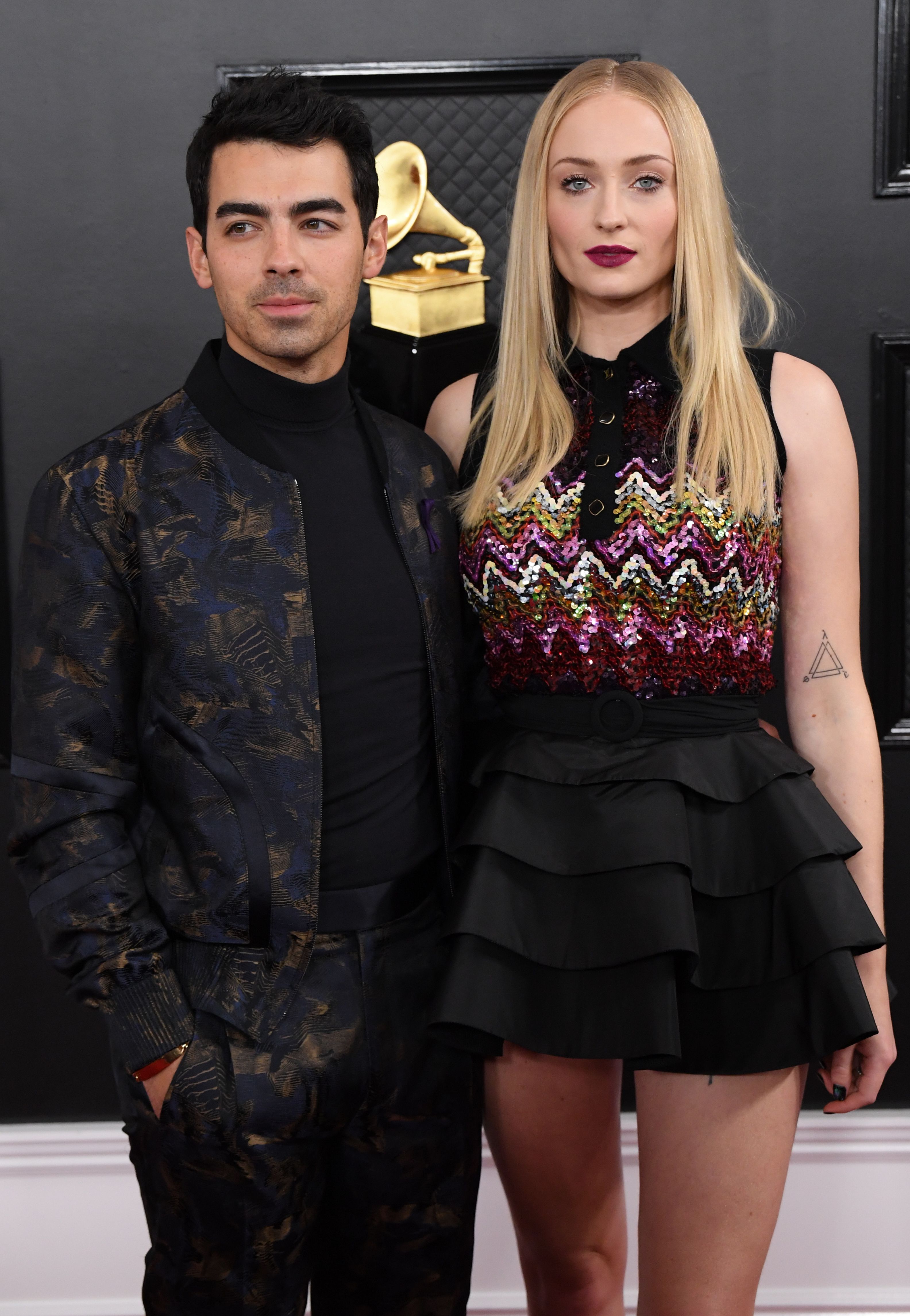 Sophie Turner Black Skirt Patterned Top Husband Joe Jonas All Black Suit Grammys