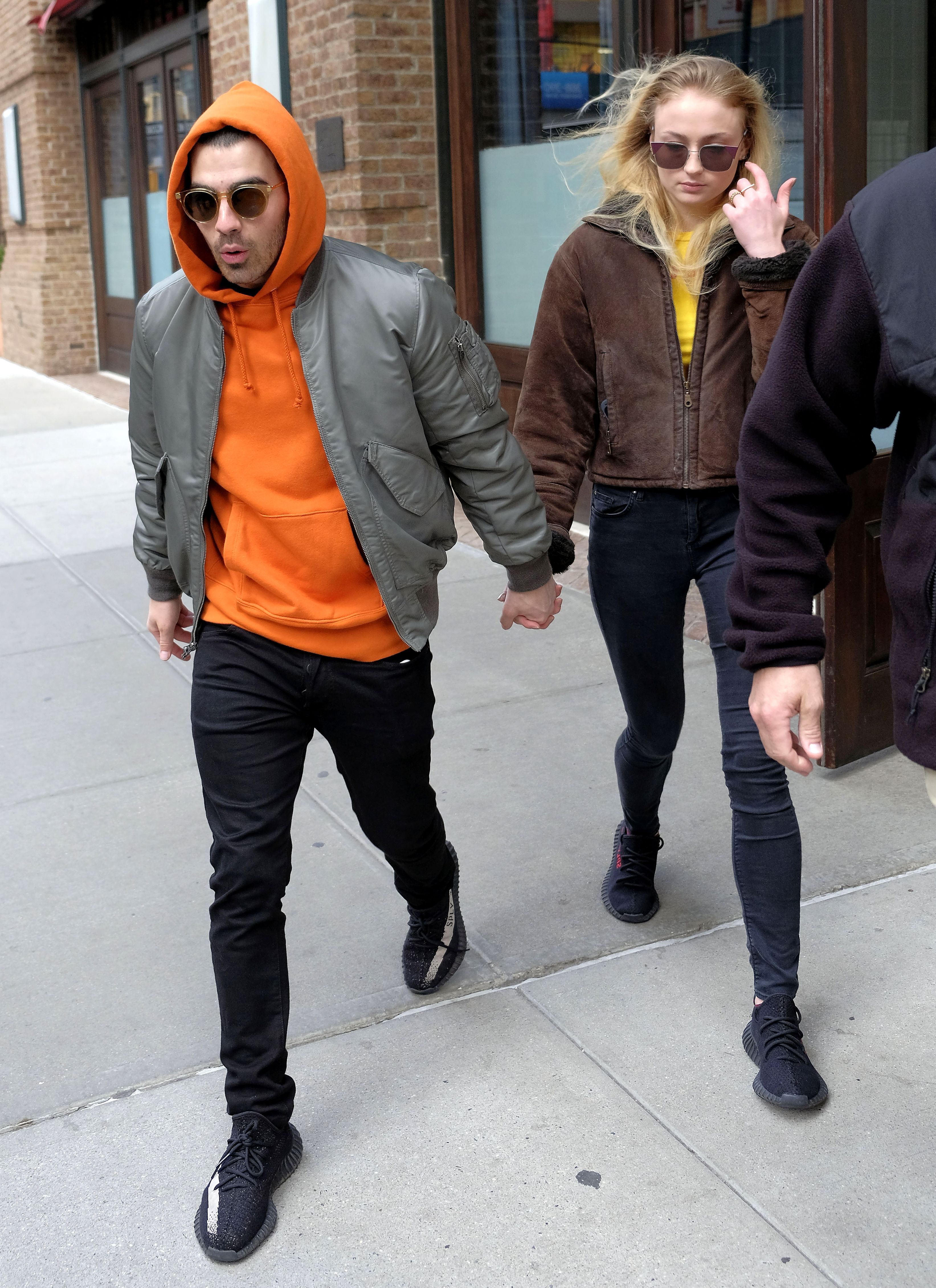 Joe Jonas Orange Hoodie Puffer Jacket Sophie Turner Brown Jacket Holding Hands