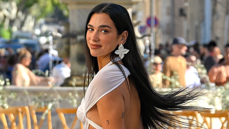 https://www.lifeandstylemag.com/wp-content/uploads/2022/08/Dua-Lipa-Wears-White-Sheer-Dress-to-Wedding-Feature.jpg?crop=0px%2C20px%2C1428px%2C808px&resize=940%2C529&quality=86&strip=all