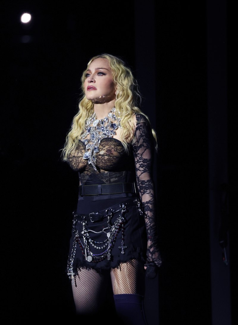 Madonna wearing all black and performing on stage in London