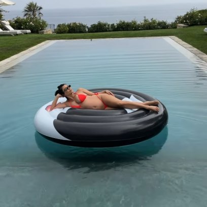 Kourtney Kardashian floating in the pool