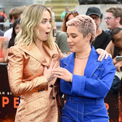 Emily Blunt having a wardrobe malfunction on the red carpet while Florence Pugh helps her