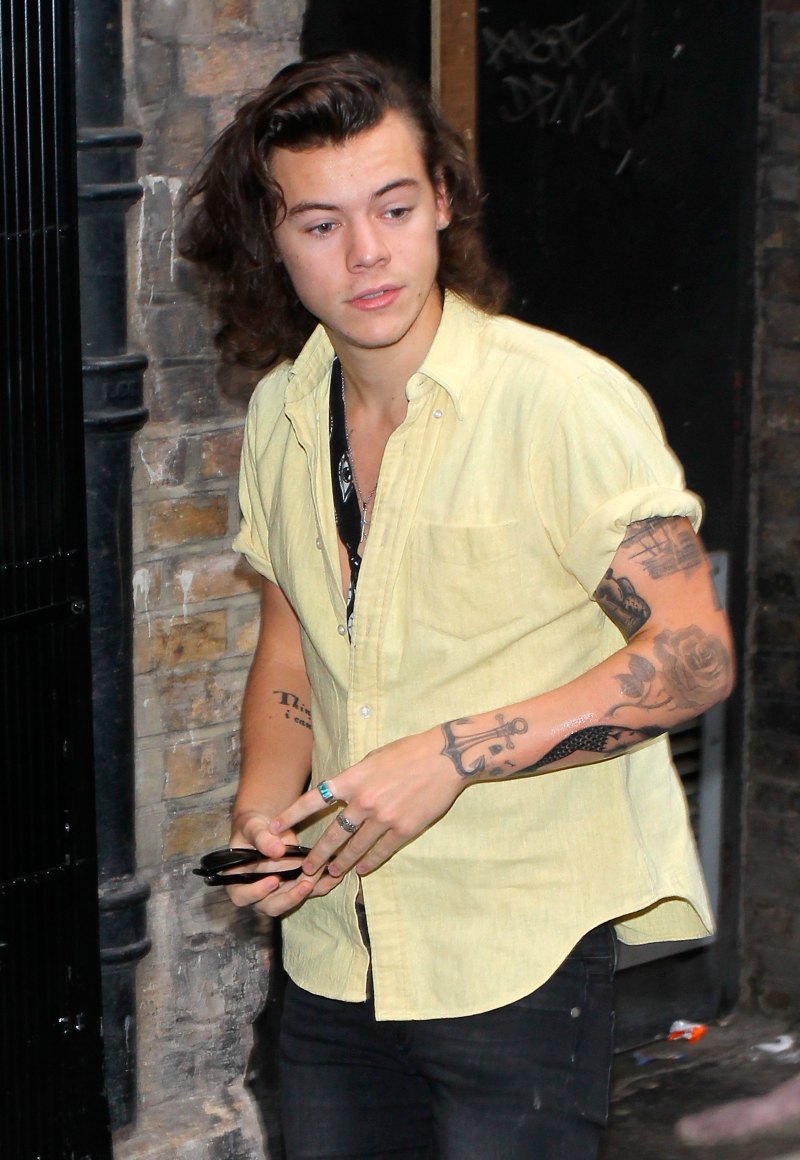 Harry Styles wearing a yellow collared shirt