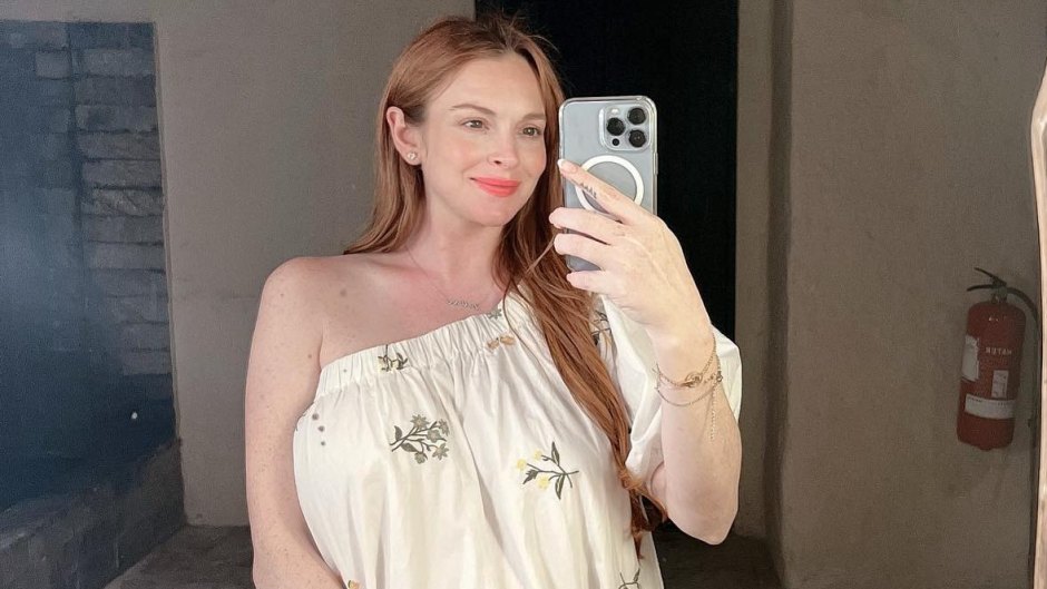 Lindsay Lohan wearing a white dress taking a selfie