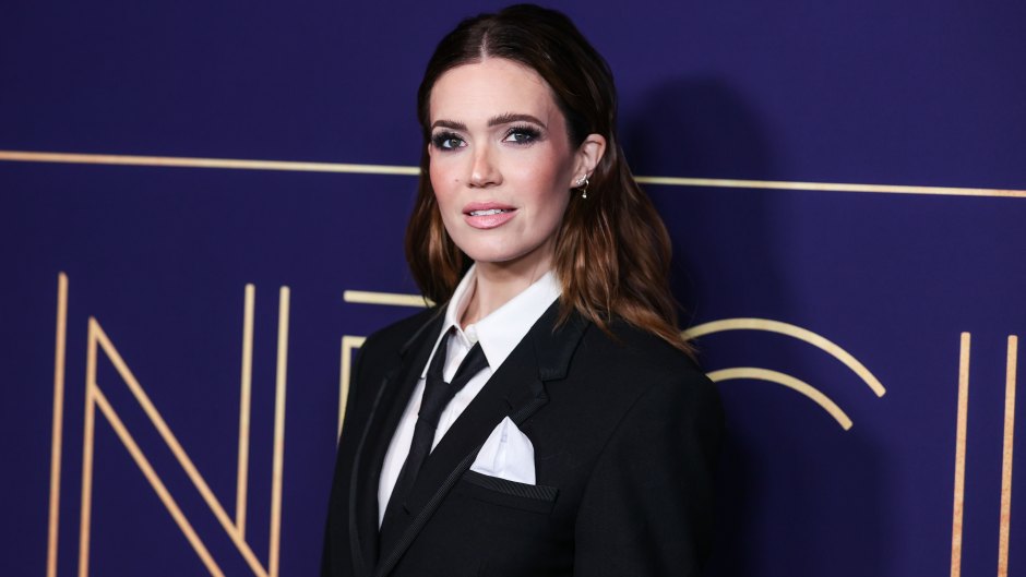 Mandy Moore wearing a black tie and suit
