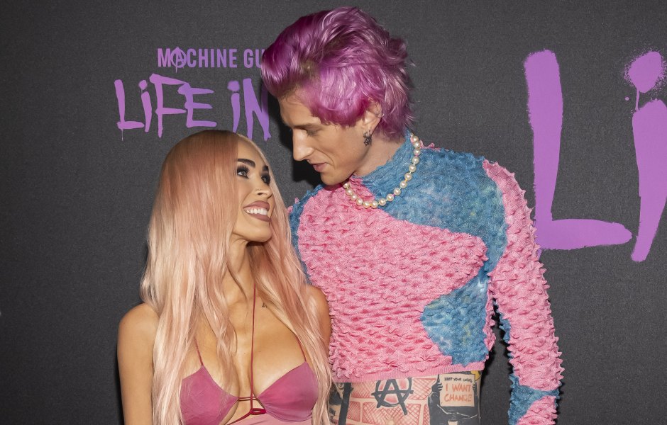 Megan Fox and Machine Gun Kelly smiling at each other at the premiere of his film Life in Pink