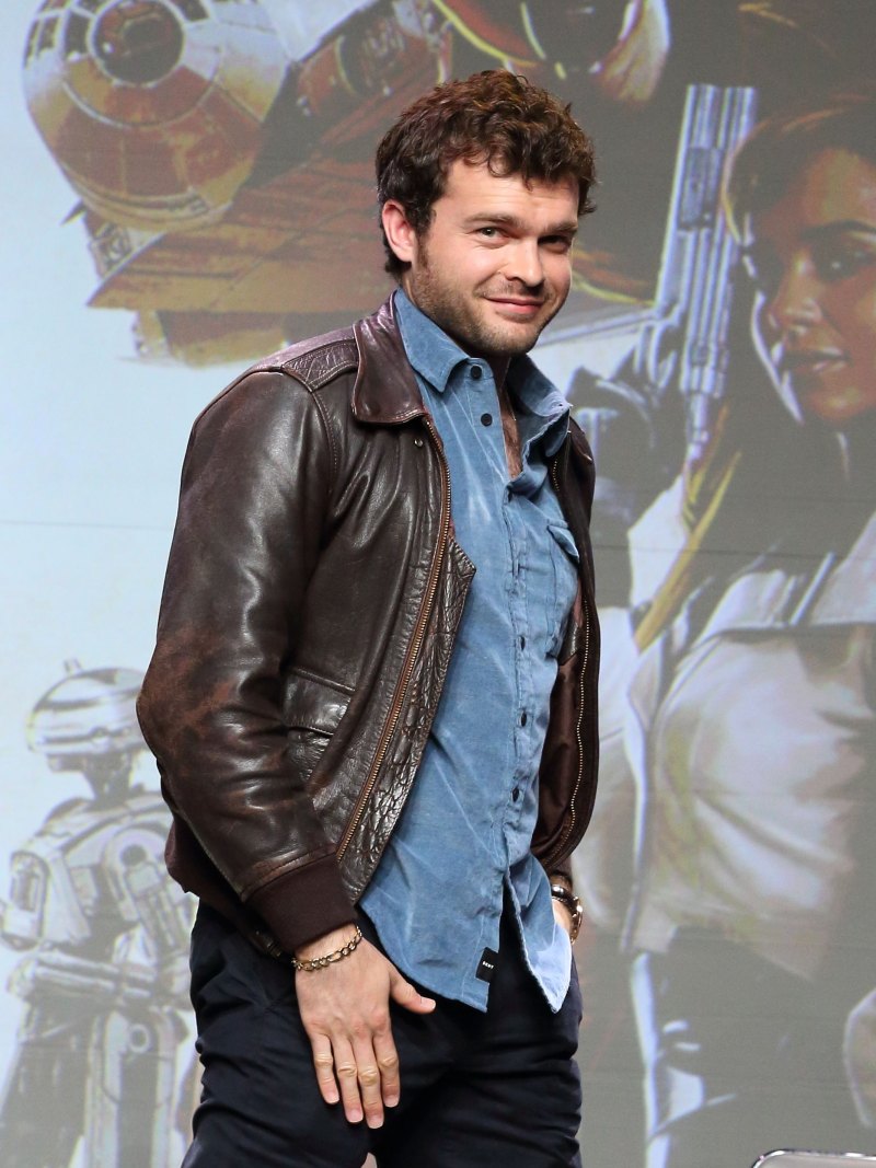 Alden Ehrenreich wearing a brown leather jacket at an event for Solo a Star Wars Story
