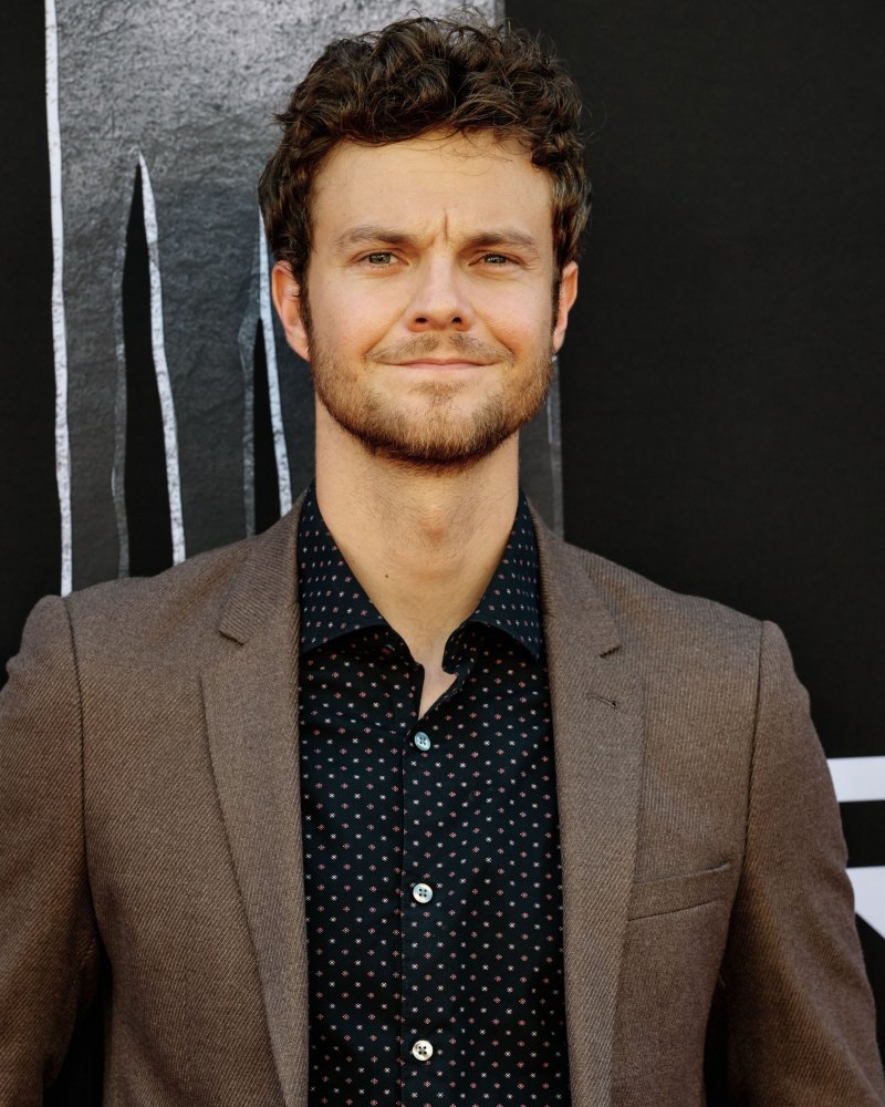 Jack Quaid wearing a brown blazer at the Prey film premiere