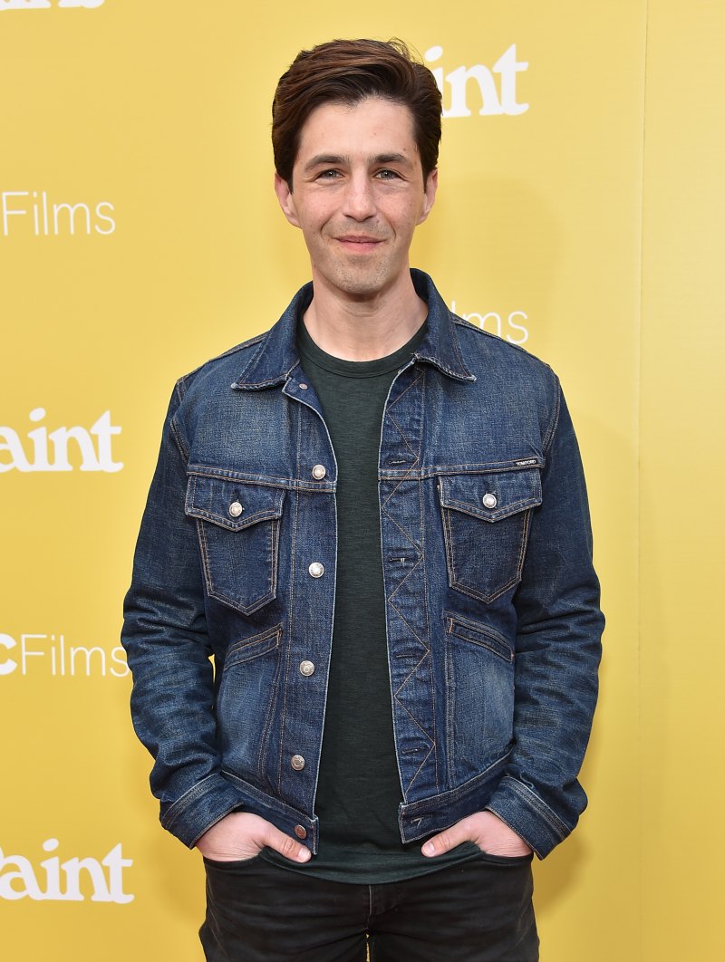 Josh Peck wearing a denim jacket while posing for cameras