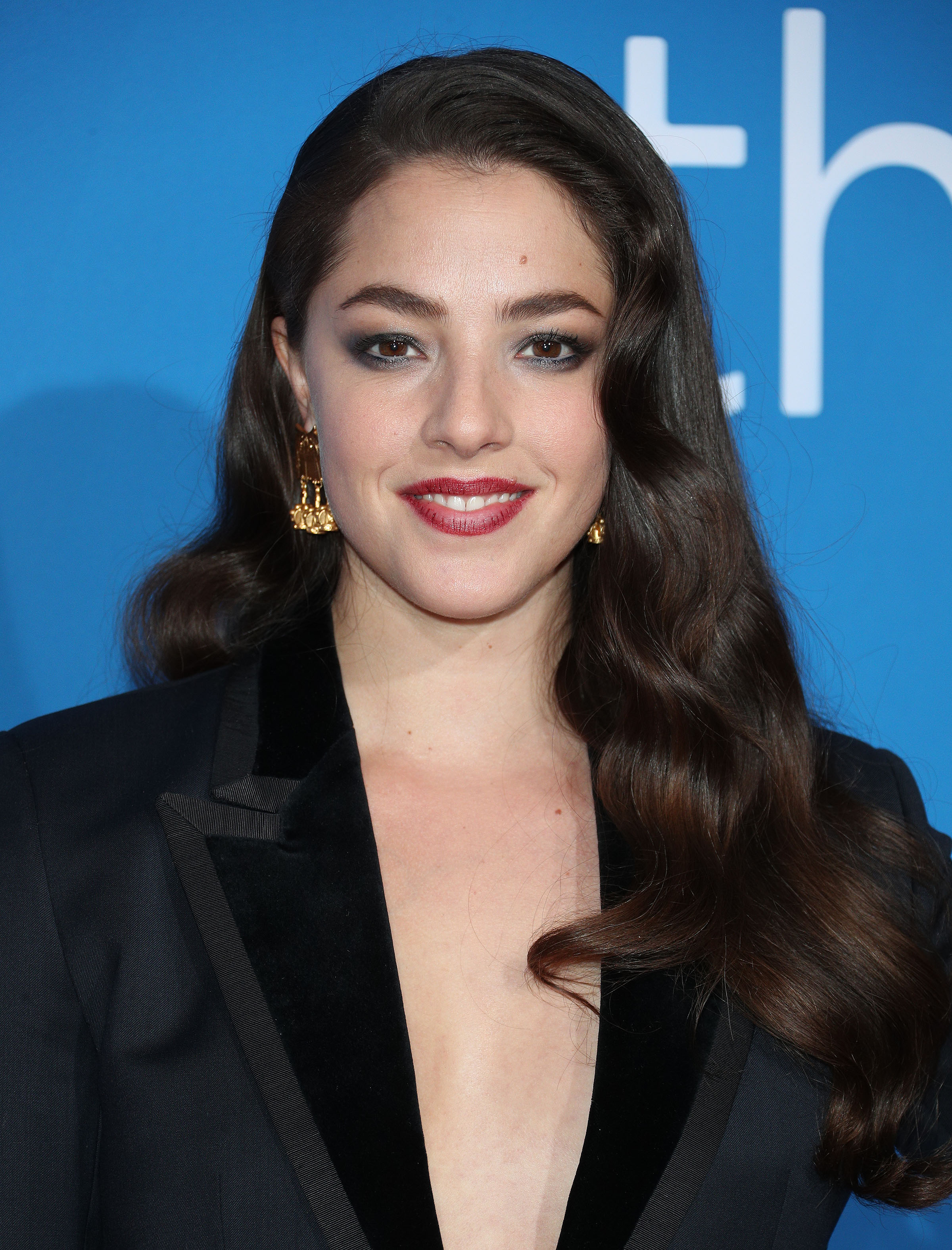 Olivia Thirlby wearing a black low-cut V-neck blazer