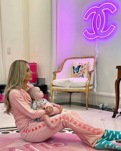 Paris Hilton and her son Phoenix looking up at a Coco Chanel sign