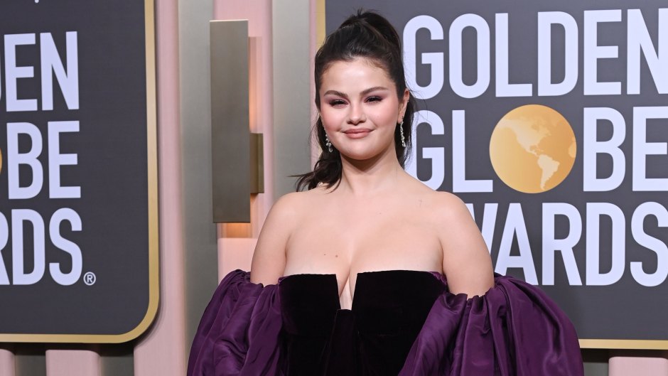Selena Gomez poses in a black dress with purple puff sleeves
