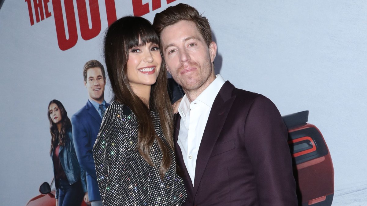 Nina Dobrev posing with boyfriend Shaun White on the red carpet