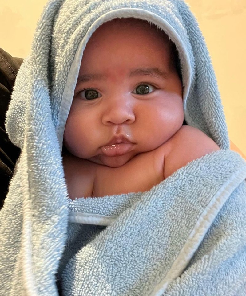 Khloe Kardashian's son Tatum with chubby cheeks wrapped in a blue towel