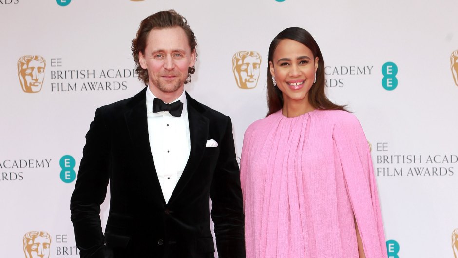 Tom Hiddleston and Zawe Ashton hold hands on a red carpet