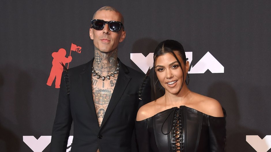 Travis Barker and Kourtney Kardashian pose for photos on the red carpet at the 2021 MTV VMAs