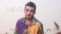Angus Cloud wearing a multi-colored colalred T-shirt at a Revolve event