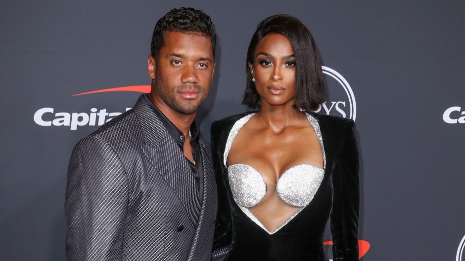 Russell Wilson posing next to Ciara on the red carpet