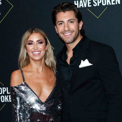 Kaitlyn Bristowe and Jason Tartick smiling for pictures on the red carpet at the 2019 People's Choice Awards